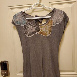 Elevated tshirt. Has flower patch work with silver threading and a sexy bow